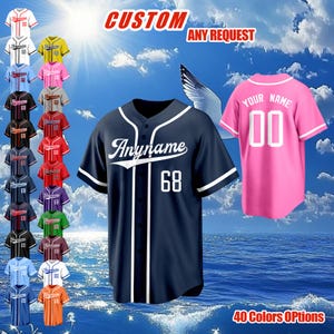 May include: A navy blue baseball jersey with white accents, the text "Anyname" and the number "68". A pink jersey with "YOUR NAME" and the number "00" is also shown. The image displays a variety of baseball jerseys in different colors. Text reads "CUSTOM ANY REQUEST" and "40 COLORS OPTIONS".