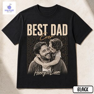 A black t-shirt with a printed design featuring a smiling father embracing his son.