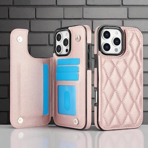 May include: Pink leather phone case with a quilted pattern and a magnetic closure. The case has a wallet feature with slots for cards and a snap closure. The phone case is designed to fit a smartphone.