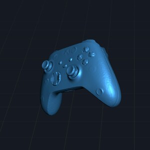 May include: A blue video game controller with multiple buttons, directional pad, and analog sticks. The controller has a textured surface and is designed for gaming. The overall design is ergonomic and modern.