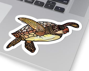 May include: A sticker featuring a cartoon sea turtle with a white border. The turtle has a brown and yellow shell, with a yellow underbelly and brown head and flippers. The sticker is placed on a laptop.