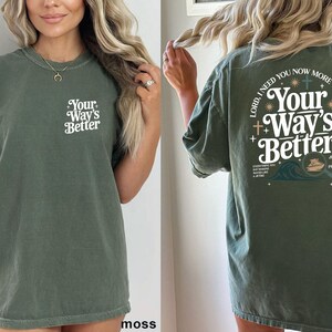 A woman wearing a green t-shirt with the text "Your Way's Better" printed on it.