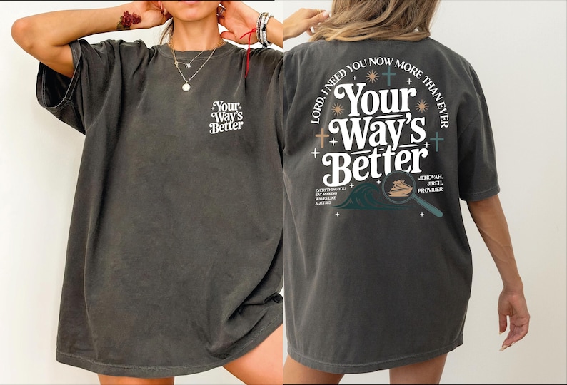 A woman wearing a gray t-shirt with text and graphics on the back.
