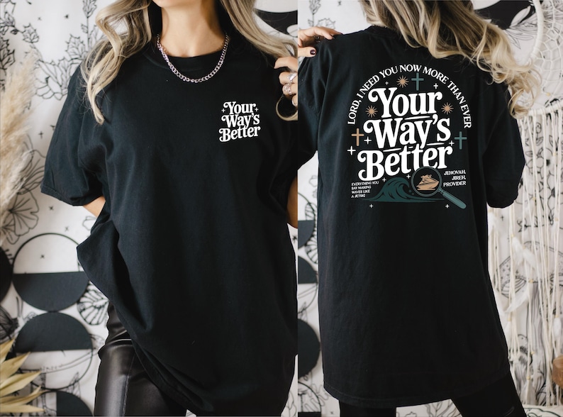 a woman wearing a black t-shirt with a design on the back.
