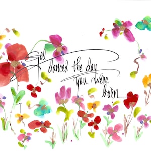 May include: Watercolor painting of colorful flowers with the text "God danced the day you were born" in black calligraphy.