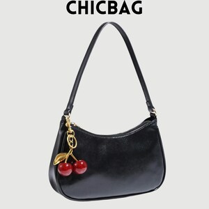 May include: Black shoulder bag with a gold zipper and a cherry charm. The bag has a curved shape and a long strap. The text "CHICBAG" is at the top of the image.