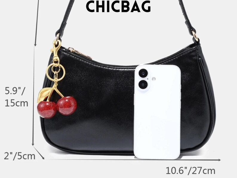 May include: Black shoulder bag with a cherry charm. The bag is 10.6 inches (27 cm) wide, 5.9 inches (15 cm) high, and 2 inches (5 cm) deep. The bag has a gold zipper and a gold cherry charm with red cherries and green leaves. The word CHICBAG is at the top.