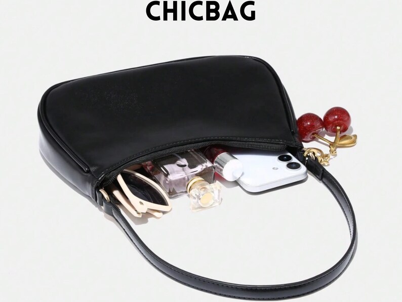 May include: Black handbag with a curved design, open to reveal contents including a smartphone, sunglasses, and perfume bottles. A cherry charm hangs from the strap. The word CHICBAG is printed at the top.