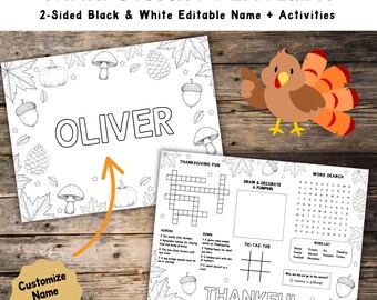 May include: Thanksgiving placemat with the text "OLIVER" and "THANKFUL". The black and white placemat features a crossword puzzle, tic-tac-toe, and a word search. The placemat is decorated with pumpkins, acorns, and leaves.