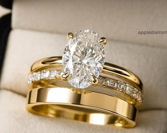 May include: A gold ring set consisting of three bands. The central band features an oval-cut clear stone, a second band is adorned with small baguette-cut stones, and a third is a plain polished gold band. The text applediamond is visible.