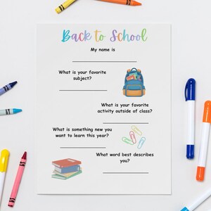 May include: A white Back to School questionnaire sheet featuring prompts like My name is, What is your favourite subject, and What word best describes you, decorated with a blue backpack, paper clips, and a stack of books, surrounded by colourful crayons and markers.