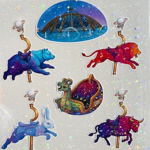 May include: A sticker bundle featuring a constellation carousel theme. The stickers include a bear, lion, dragon, rabbit, and bull, each with a carousel seat and a planet-shaped topper. The text reads "EPIC UNIVERSE CONSTELLATION CAROUSEL Sticker Bundle!"