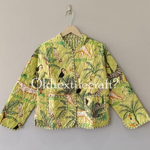 May include: A lime green quilted jacket featuring a jungle print with leopards, toucans, and palm trees. The jacket has a mandarin collar, long sleeves, two front patch pockets, and a light green and white checkered trim along the edges.