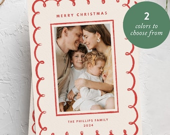 May include: A Christmas card with a red border featuring a family of four. The card says "Merry Christmas" and "The Phillips Family 2023".