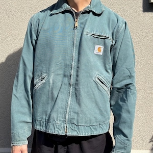 Vintage Carhartt Detroit-jas: groenblauwe werkkledingjas, distressed fade, m/l