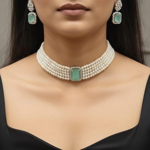 May include: A multi-strand pearl choker necklace featuring a central rectangular mint green stone set in a silver-toned frame, accompanied by matching drop earrings with a similar mint green stone and a cluster of small clear crystals.