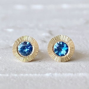 Large Aurora Stud Earrings, Blue Montana Sapphire and Yellow gold halo with engraving, radiant sunburst engraved border, second hole post image 1