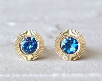 Large Aurora Stud Earrings, Blue Montana Sapphire and Yellow gold halo with engraving, radiant sunburst engraved border, second hole post