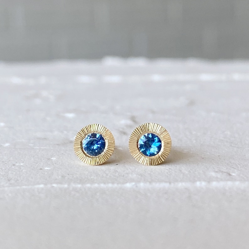 Large Aurora Stud Earrings, Blue Montana Sapphire and Yellow gold halo with engraving, radiant sunburst engraved border, second hole post image 1