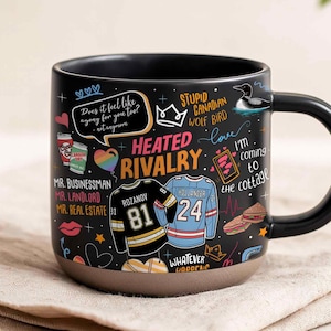 May include: Black ceramic mug with a black handle and a brown base. The mug features a design with hockey jerseys, the words "Heated Rivalry", and other graphics. Text includes "Does it feel like agony for you too?" and "I'm coming to the cottage."