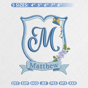 May include: Embroidered design featuring a blue shield with the letter "M" and the name "Matthew" on a banner. A kite and floral accents are included. The design is available in 5 sizes: 4", 5", 6", 7", and 8".