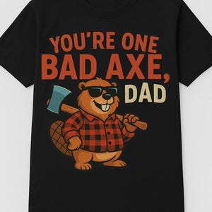 May include: Black t-shirt with the text "YOU'RE ONE BAD AXE, DAD." A cartoon beaver wearing sunglasses and a red and black plaid shirt is holding an axe. The beaver is brown with a large tail.