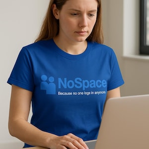May include: A blue t-shirt with the text "NoSpace" and the tagline "Because no one logs in anymore." The shirt is being worn by a person using a laptop.