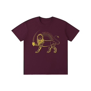 May include: A maroon t-shirt with a gold lion and sword design, set against a sunburst. The lion is depicted in a detailed, stylized manner. The shirt has a crew neck and short sleeves, and is a solid maroon colour.