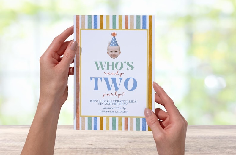 May include: A birthday party invitation with a baby's face wearing a party hat. The invitation has a striped border in pastel colors and text that reads "WHO'S ready TWO party?" and event details.