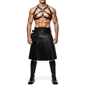 May include: A black leather kilt with a matching belt and pouch, paired with a black leather harness. The outfit includes black lace-up boots, creating a bold and edgy ensemble.