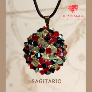 May include: A beaded pendant necklace with a round, multi-colored pendant. The pendant is made of red, black, and green beads. The necklace has a black cord and a bronze-colored clasp. The word "SAGITARIO" is at the bottom.