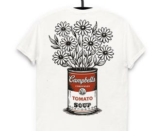 May include: White t-shirt with a graphic of a Campbell's Tomato Soup can holding daisies. The can is red and white with the words "Campbells Condensed Tomato Soup". The daisies are black and white, creating a striking contrast.