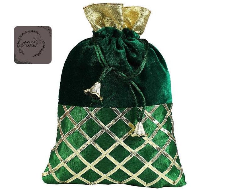 May include: A green velvet drawstring bag with gold accents. The bag features a gold lattice pattern on the lower section and a gold metallic top. The drawstring is tied with gold bell-shaped tassels. The bag has a decorative logo on the upper left.