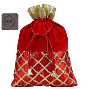 May include: A red velvet drawstring bag with gold accents. The top of the bag is gathered with a gold fabric, and the bottom features a gold diamond pattern. The drawstring is a matching red cord with gold tassels.