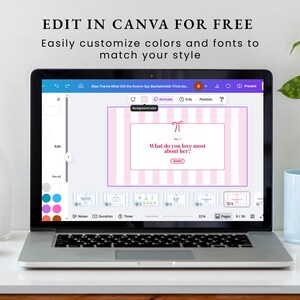 May include: A laptop displays a bachelorette trivia game template with pink and white stripes. The screen shows the text "What do you love most about her?" and "Edit in Canva for Free". A white vase and a blue mug are also visible.