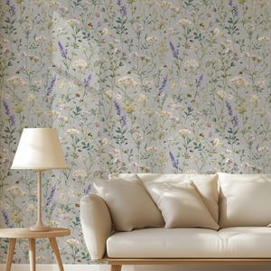 May include: A white ceramic mug with a black handle and the text "But First, Coffee" in a black, handwritten-style font. The mug is on a white surface.