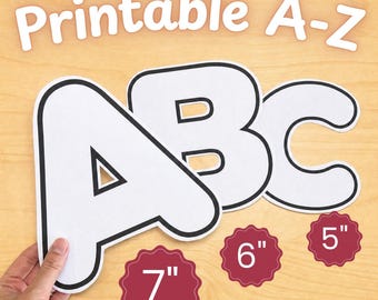 May include: White A, B, and C letters with black outlines, and the text "Printable A-Z" are displayed on a light wood surface. Three red scalloped circles show the sizes: 17.78cm, 15.24cm, and 12.7cm.