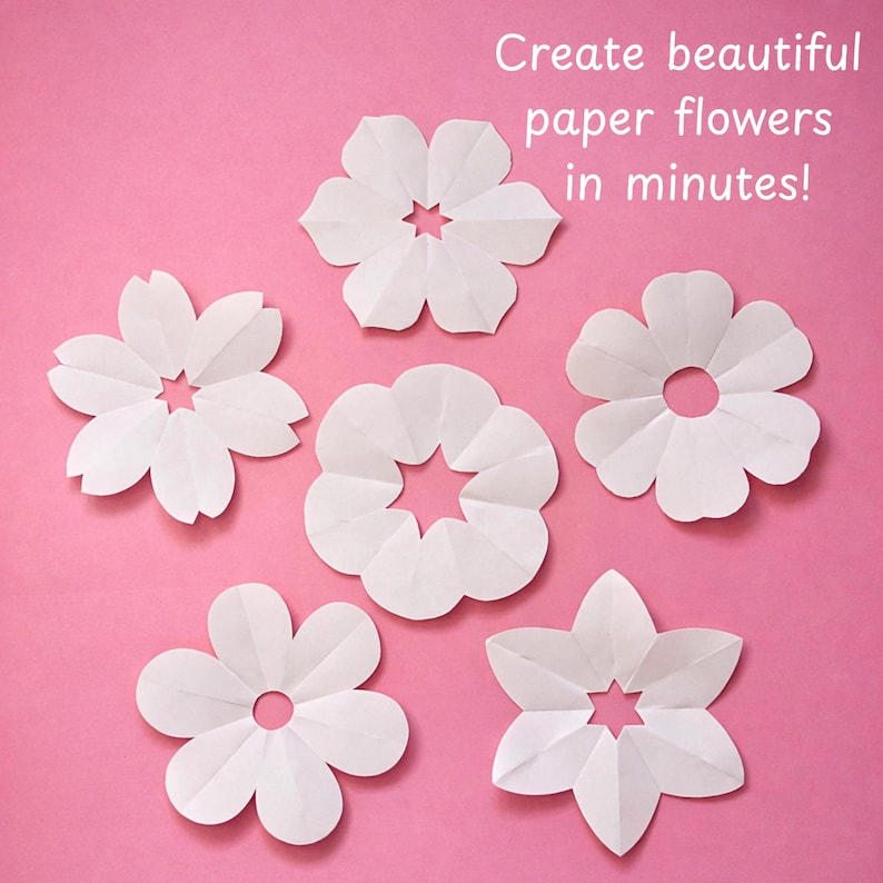 Puede incluir: Seis recortes de flores de papel blanco con diversas formas de p&eacute;talos y orificios centrales, dispuestos sobre un fondo rosa. El texto "Create beautiful paper flowers in minutes!" est&aacute; impreso en blanco en la esquina superior derecha.