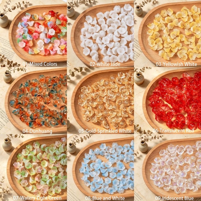 May include: A collection of nine wooden trays containing small flower-shaped beads in various colors and finishes, labeled as Mixed Colors, White Jade, Yellowish White, Dunhuang, Gold-Sprinkled White, Translucent Red, Watery Light Green, Blue and White, and Iridescent Blue.