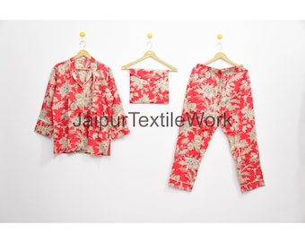 May include: Red pajama set with a floral pattern, including a button-down shirt, drawstring pants, and a small pouch. The text "Jaipur Textile Work" is printed on the image.