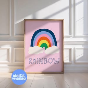 May include: A framed art print featuring a colorful rainbow design on a pink background. The rainbow has blue, orange, yellow, and green arches with white clouds below. The word "RAINBOW" is written in blue script. A digital download graphic is in the bottom left.