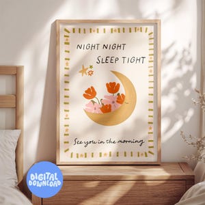 May include: A framed art print with a whimsical design. The artwork features a crescent moon filled with orange and pink flowers, with the text "NIGHT NIGHT SLEEP TIGHT" and "See you in the morning". The frame is light brown.