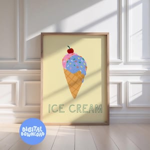 Puede incluir: Impresión enmarcada con una ilustración de un cono de helado. El helado tiene bolas rosas y azules con chispas y una cereza. El cono es de color marrón claro, y el texto "ICE CREAM" está debajo.