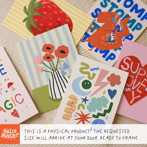 Puede incluir: Una colecci&oacute;n de coloridas impresiones art&iacute;sticas con varias ilustraciones. Los dise&ntilde;os incluyen una fresa roja, un dinosaurio, flores en un jarr&oacute;n y formas abstractas. Las impresiones est&aacute;n dispuestas sobre una superficie neutra.
