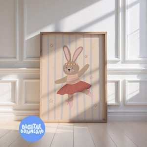 May include: A framed digital print featuring a cartoon bunny ballerina. The bunny wears a pink tutu, ballet shoes, and a headband. The background has vertical stripes and star accents. The words "DIGITAL DOWNLOAD" are in a blue circle at the bottom.
