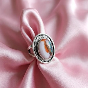 May include: A set of three ceramic mugs with a speckled, matte finish. The mugs are in shades of cream, light gray, and dark gray. Each mug has a simple, minimalist design, perfect for coffee or tea.