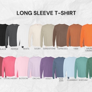May include: A color chart displaying fourteen long sleeve t-shirts in various shades including black, pepper, white, ivory, sandstone, espresso, yam, brunt orange, brick, crunchberry, blossom, orchid, violet, blue jean, chambray, seafoam, and light green.