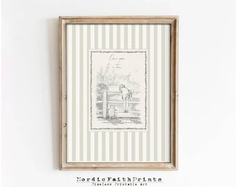 May include: A framed print with a black and white illustration of a boy and a bear by a fence. The print has a striped background and the words "Once upon a time". The frame is light brown.