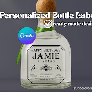 May include: A clear glass bottle with a cork stopper and a personalized label. The label reads "HAPPY BIRTHDAY JAMIE 21 YEARS" with a bee illustration. The bottle has a green ribbon and the text "Personalized Bottle Label" at the top.