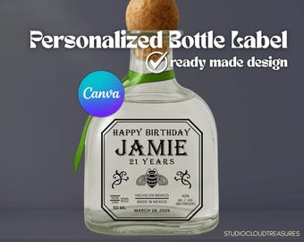 May include: A clear glass bottle with a cork stopper and a personalized label. The label reads "HAPPY BIRTHDAY JAMIE 21 YEARS" with a bee illustration. The bottle has a green ribbon and the text "Personalized Bottle Label" at the top.